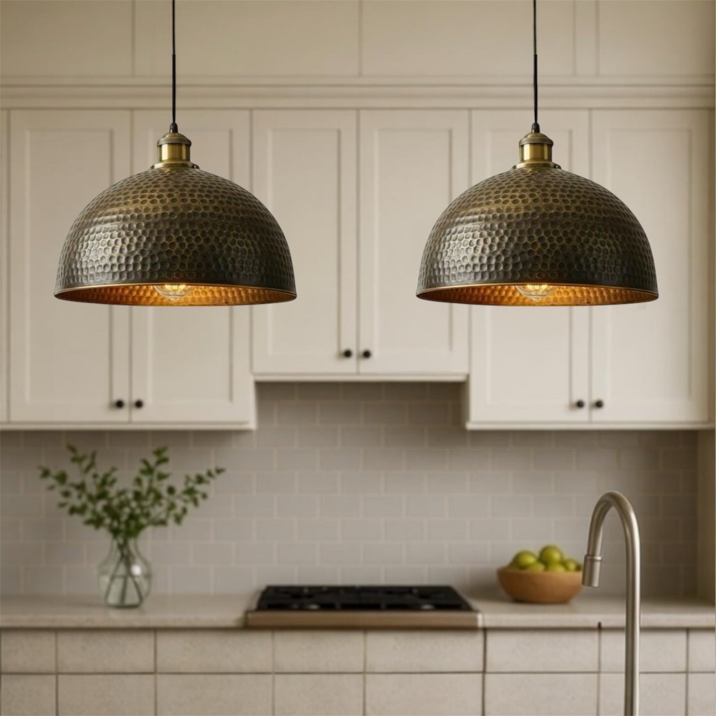 Kitchen with two hanging pendant lights, white cabinets, and a tiled backsplash.