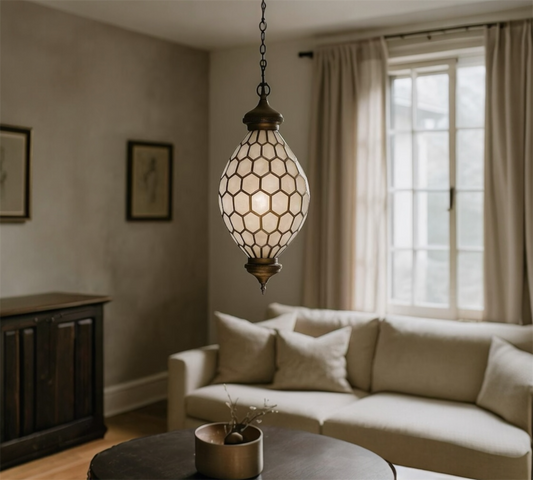 Decorative hanging lamp in a living room with a couch and window.