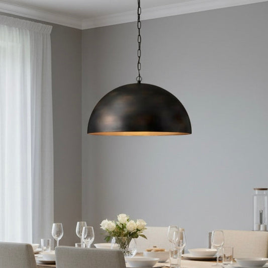 Close-up of the antique brass finish on a minimalist handmade dome lighting fixture.