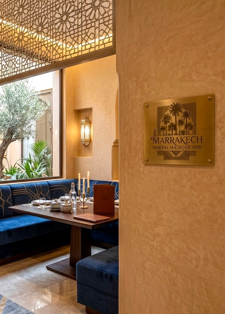 Personalized commercial solid brass nameplate sign installed on textured wall in upscale restaurant interior.