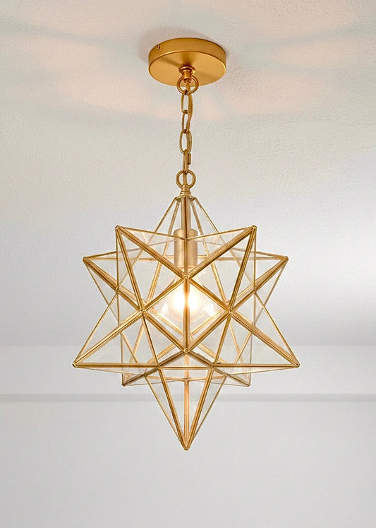 Handmade Moroccan Moravian star pendant light in polished brass gold finish with clear glass panels.
