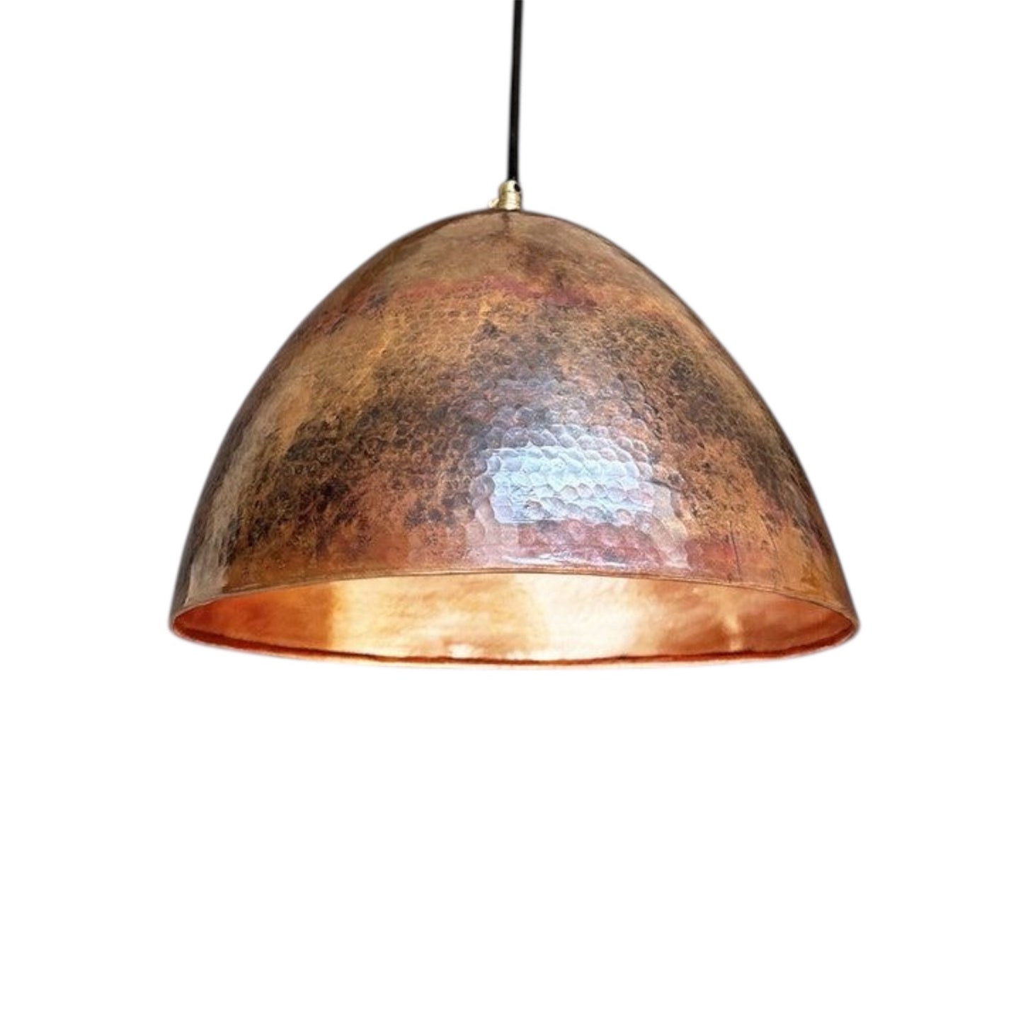Handmade hammered copper dome pendant light isolated on white background.