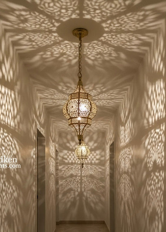 Close-up of a hand-engraved brass pendant light showing traditional Moroccan artisan craftsmanship and metal piercing.