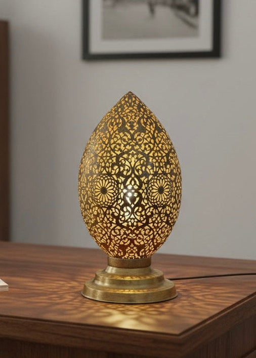 Close-up of hand-pierced metalwork detailing on a traditional Moroccan brass lamp.