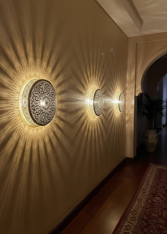 Handcrafted intricate perforated brass wall sconce with traditional geometric patterns.