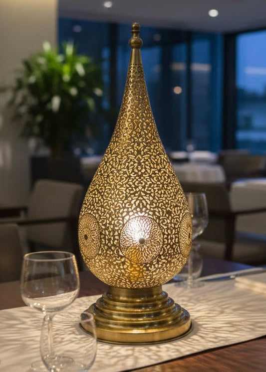 Close-up of the hand-pierced floral motifs and craftsmanship on a Moroccan brass lamp.