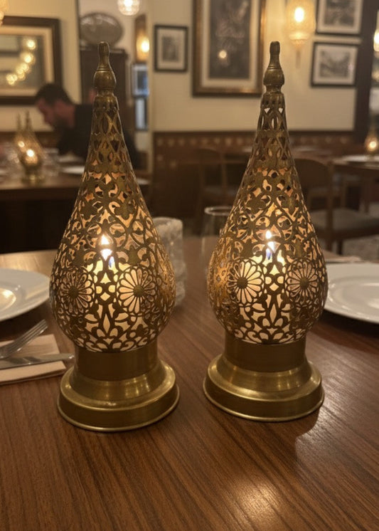 Close-up of a handcrafted Moroccan brass candle lamp showing intricate filigree brass works .