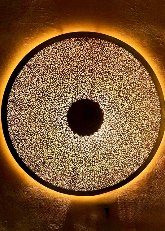 Detailed view of 100% handmade Moroccan brass wall lamp with intricate hand-carved patterns.