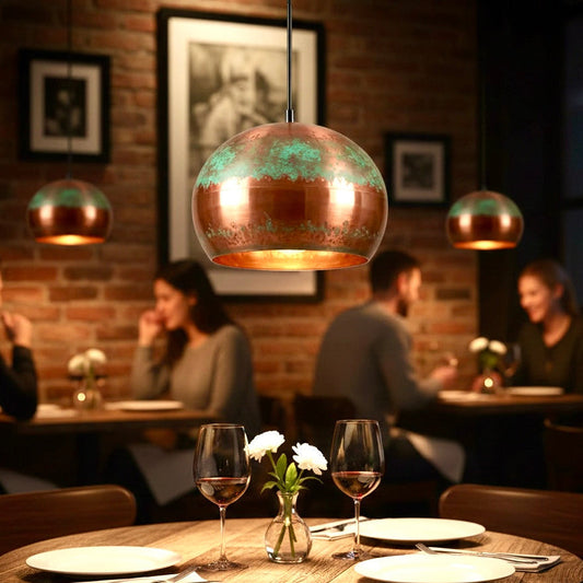 Handmade oxidized copper dome pendant lamps lighting a cozy rustic restaurant interior.
