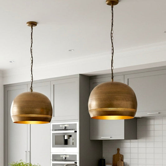 Industrial style brass dome ceiling light with vintage finish and chain.