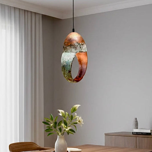 Minimalist bedside lighting with a unique green patina ring pendant on a wooden side table.