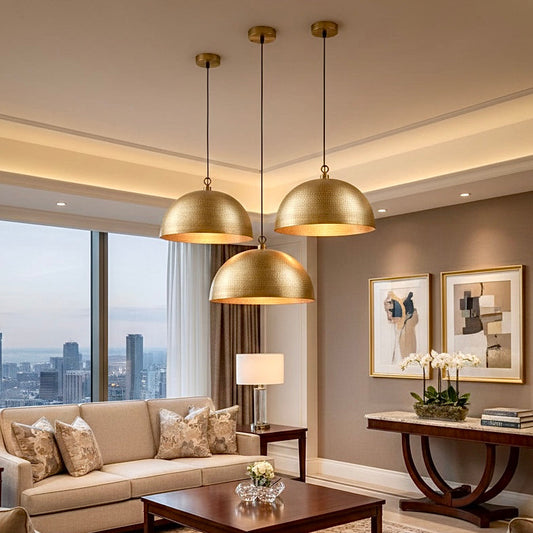 Set of three hammered brass pendant lights in a modern luxury living room setting.