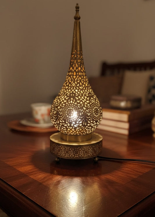 Handcrafted Moroccan brass table lamp creating warm bedroom ambient lighting
