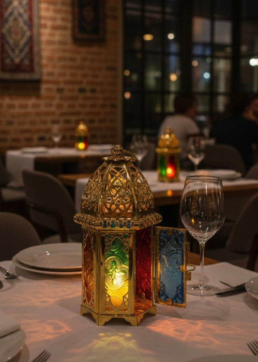 Warm glow and exotic shadow patterns cast by a Moroccan candle lantern in a dark room.
