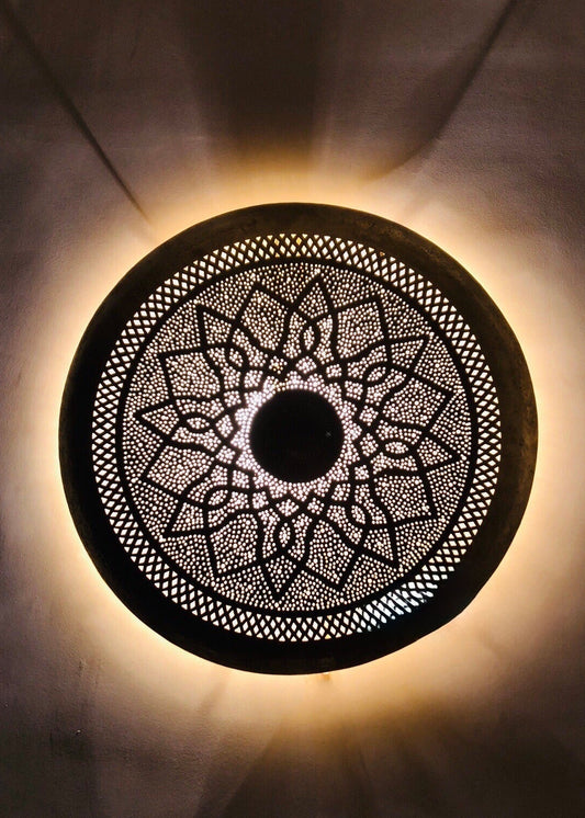 Ornate antique brass wall fixture lighting, statement piece for home interior.