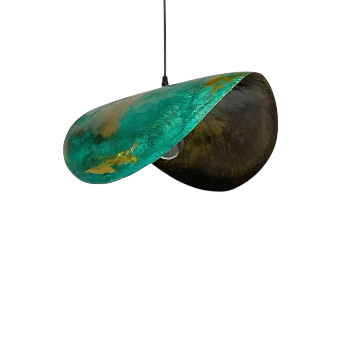 Close-up of the rustic green and gold textured finish on an oxidized brass lamp shade.