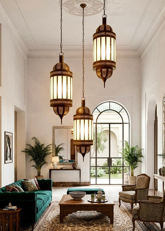 Three large handmade Moroccan brass lanterns with glass panels hanging in a grand, luxury living room with high ceilings.