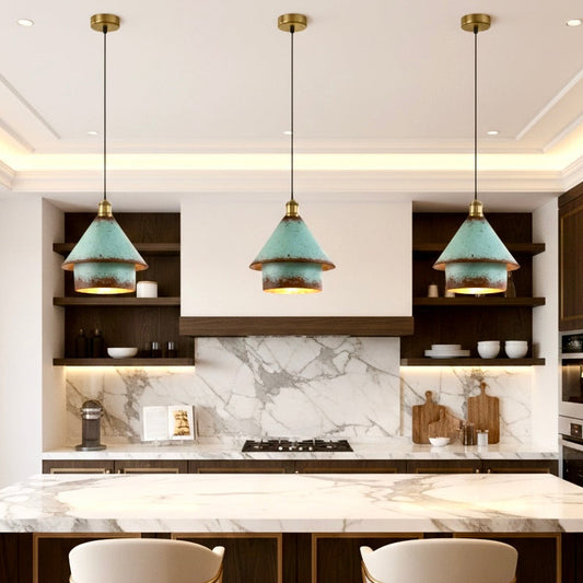 Set of three modern rustic pendant lights with patina green finish installed over a white marble kitchen island
