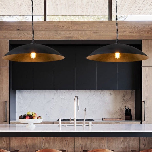 Vintage style black dome pendant light with a textured gold interior for warm ambient lighting.