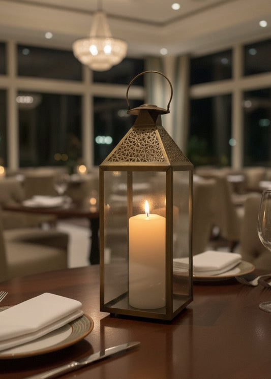 Vintage gold Moroccan candle holder with intricate geometric metal cutouts and glass panels.