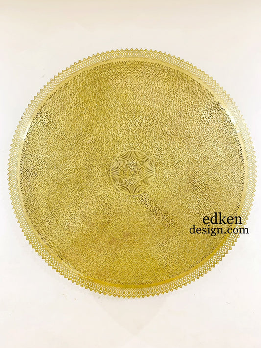 Elegant gold-finished Moroccan wall light fixture, ornate circular Brass carving for luxury home interior and ambient mood lighting.