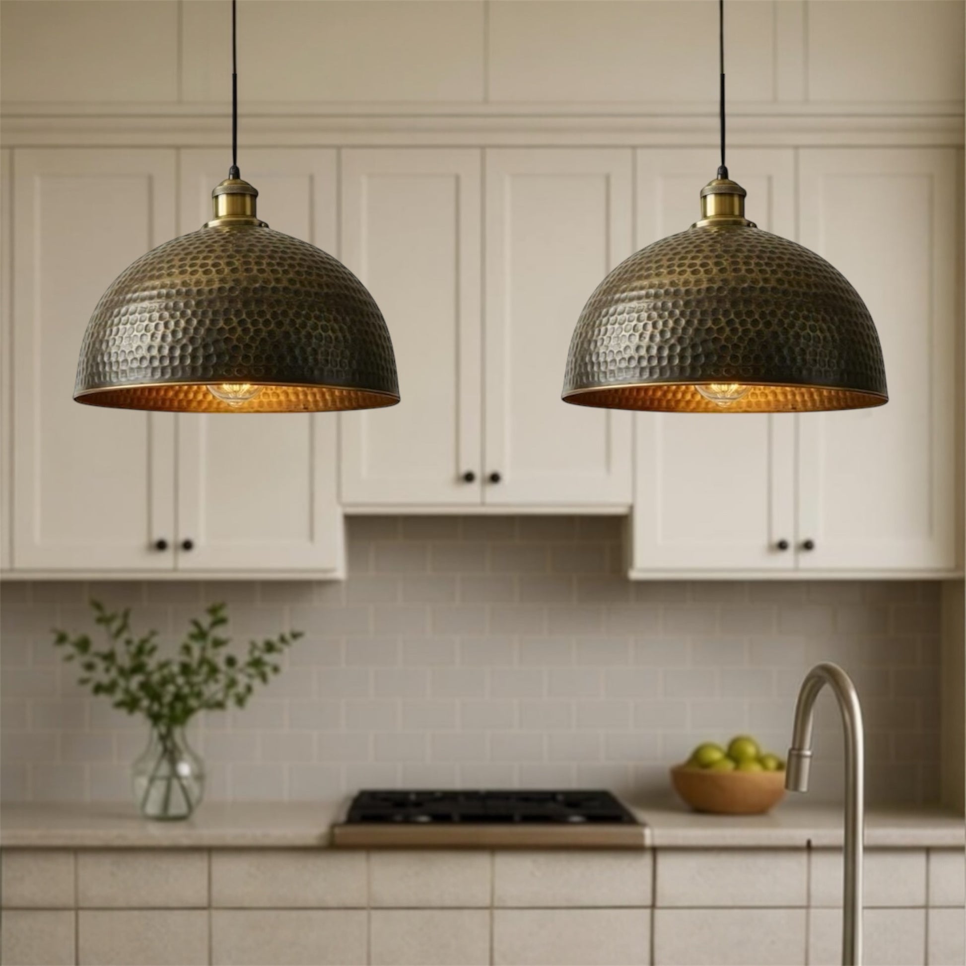 Kitchen with two hanging pendant lights, white cabinets, and a tiled backsplash.