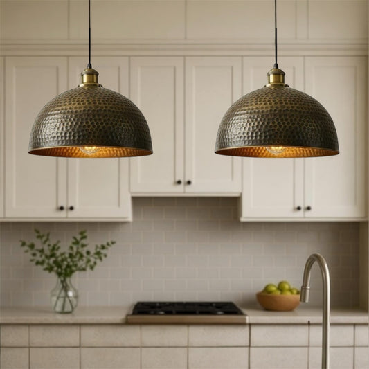 Kitchen with two hanging pendant lights, white cabinets, and a tiled backsplash.