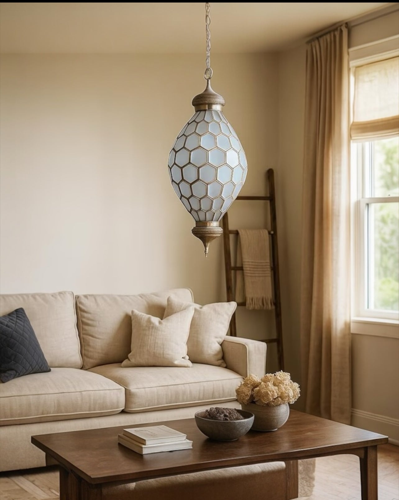 Living room with beige sofa, wooden coffee table, and decorative hanging light fixture.