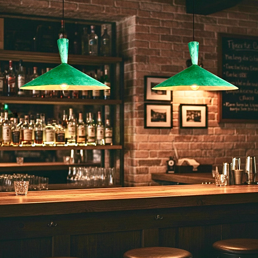 Modern brass dome pendant light with green patina in a rustic bar setting
