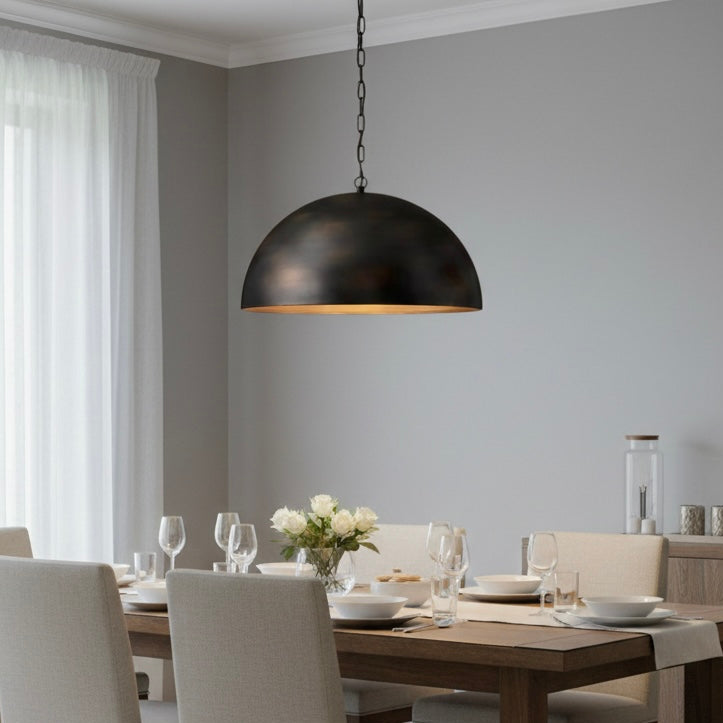 Close-up of the antique brass finish on a minimalist handmade dome lighting fixture.