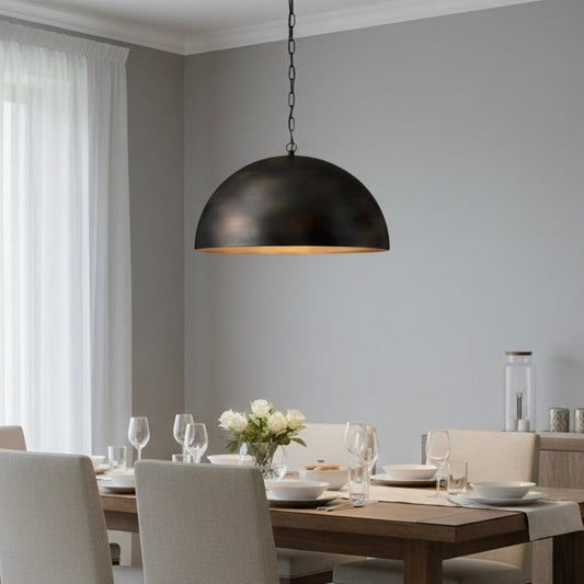 Close-up of the antique brass finish on a minimalist handmade dome lighting fixture.