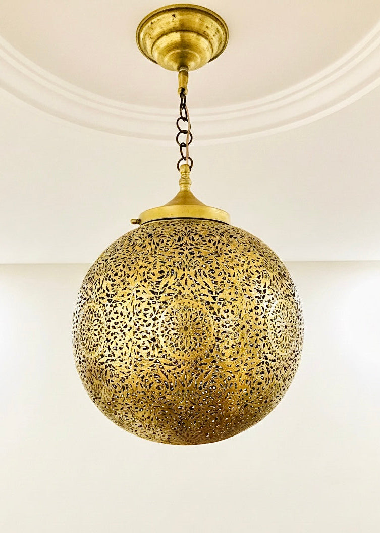 Traditional handmade antique brass Moroccan sphere lamp with intricate geometric carvings.