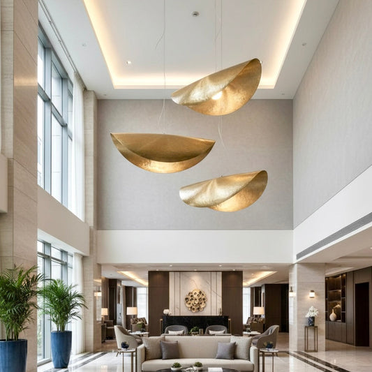 Close-up of artisan hand-hammered brass texture on a contemporary pendant light fixture