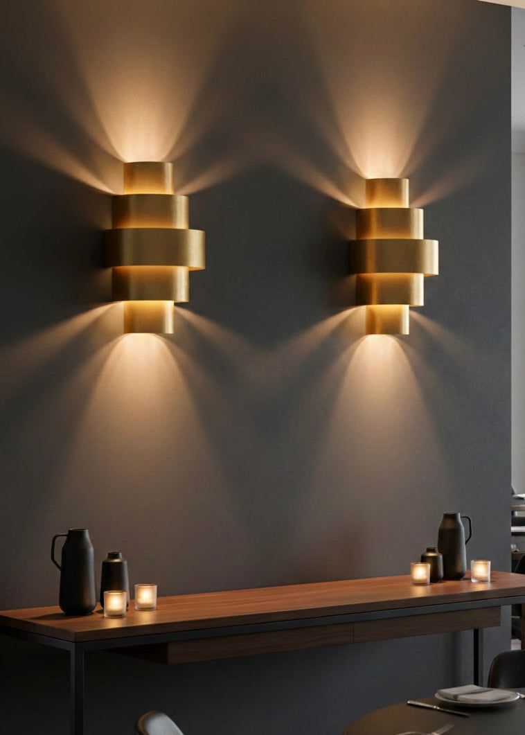 Unlit solid brass wall lamp displaying the natural gold finish and minimalist design.