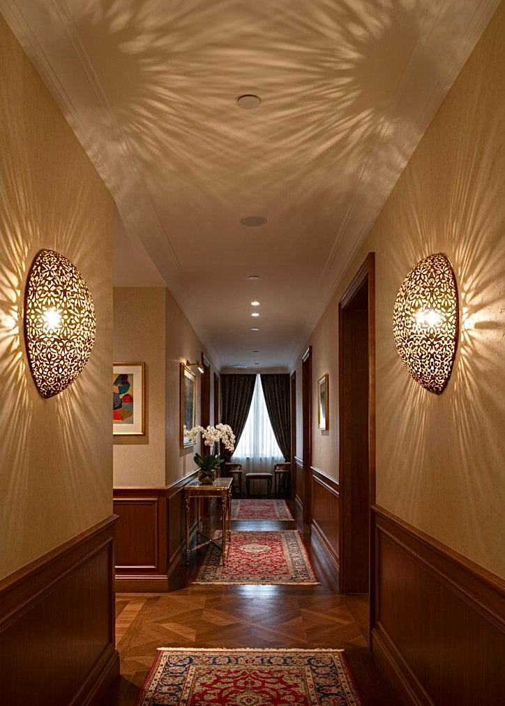 Vintage style Moroccan brass sconce shown unlit to highlight the high-quality hand-drilled perforations and metal texture.