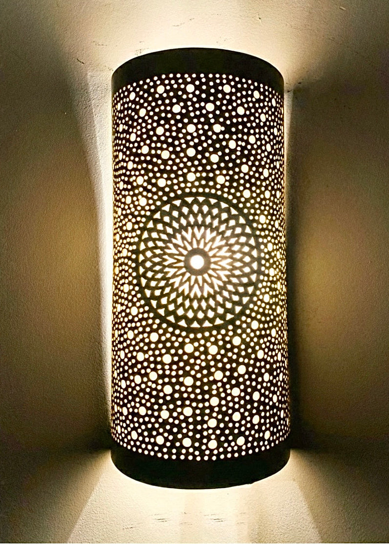 Gold brass wall sconces illuminating a cozy living room with a warm, amber glow.