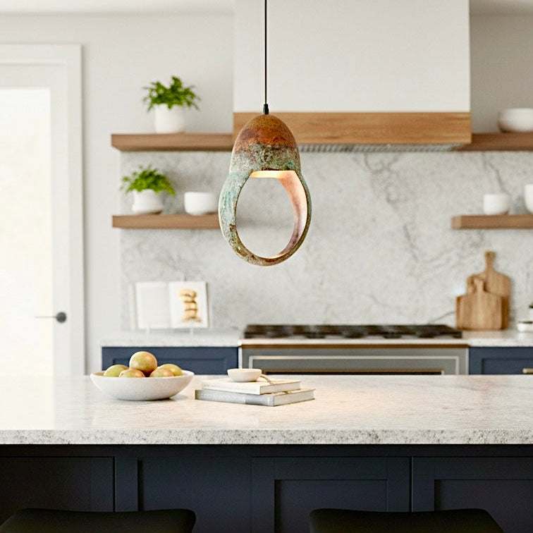 Luxury reception area featuring a grand display of green verdigris ring lamps at different heights.