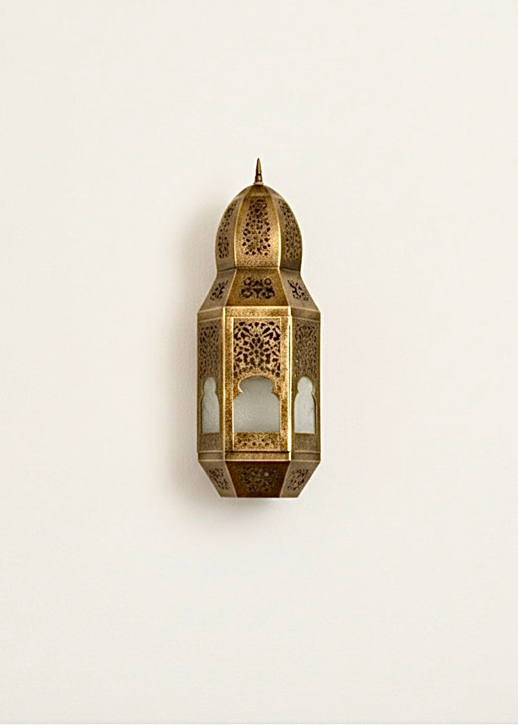 Authentic hand-engraved brass Moroccan wall light fixture showing detailed metalwork without light.