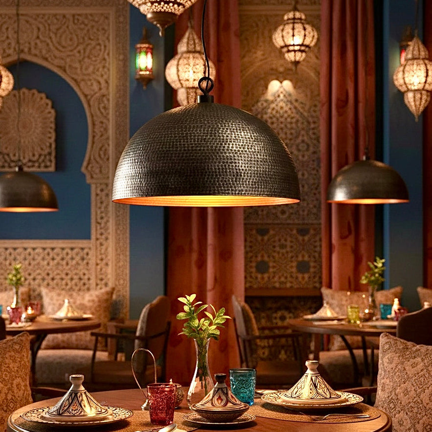 Authentic Moroccan restaurant interior decorated with handmade hammered brass dome lamps and traditional lanterns.