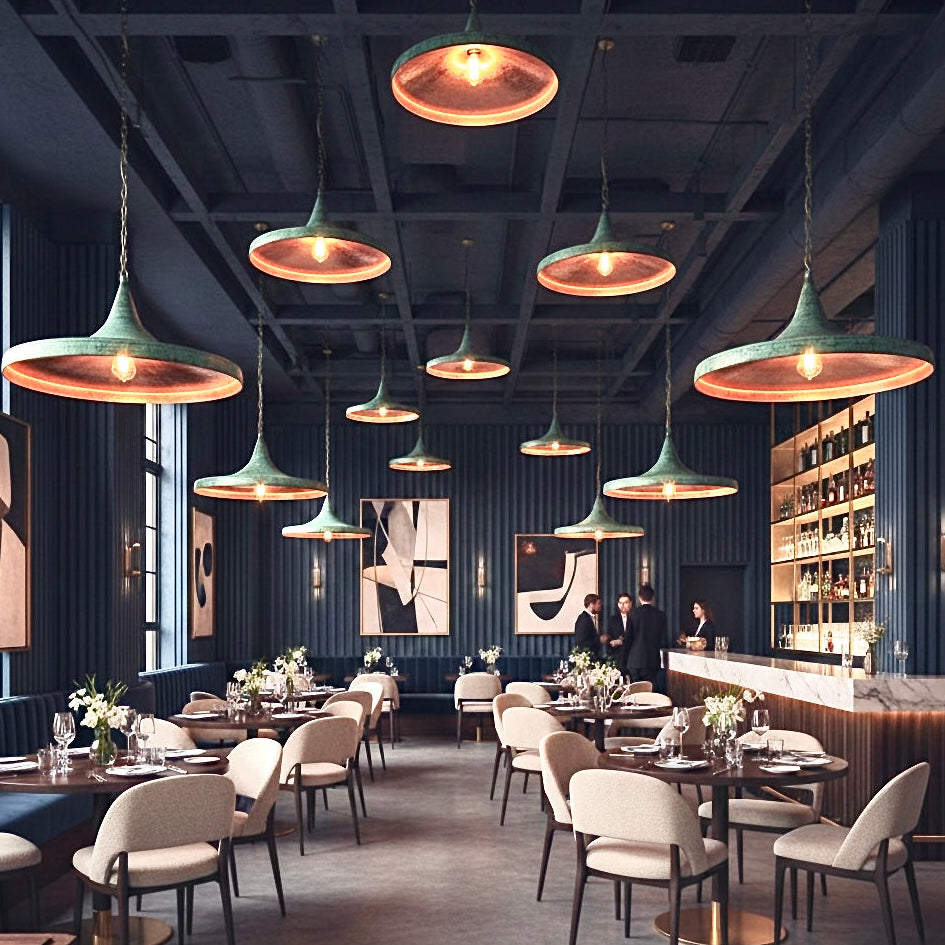 Large group of modern hammered brass dome lights with green patina installed in a stylish restaurant, available for wholesale.