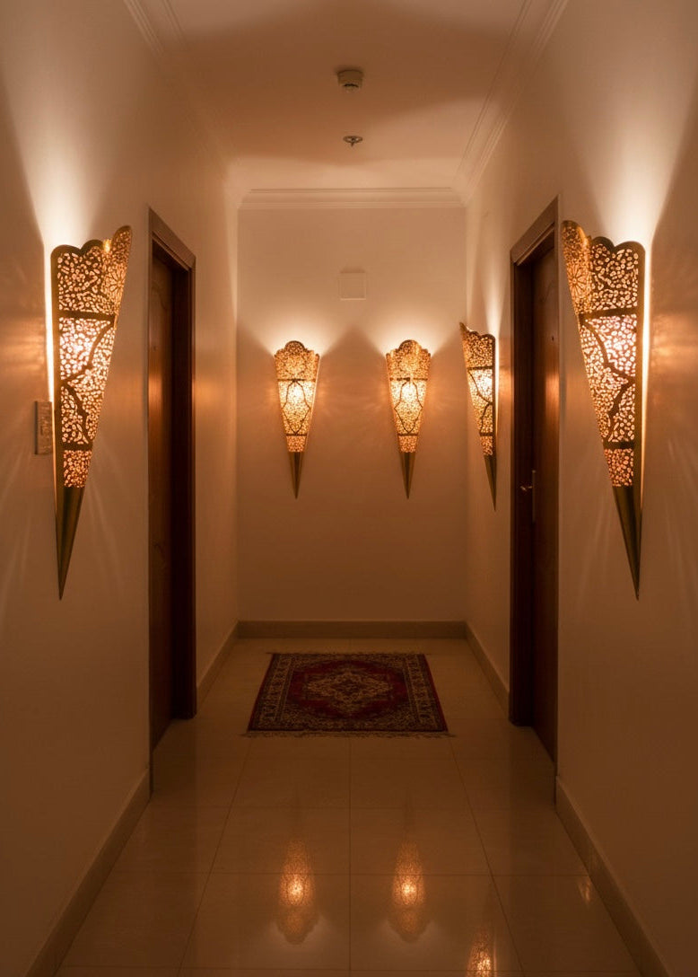 view of a cone-shaped oriental brass wall sconce showing the sleek handmade craftsmanship.