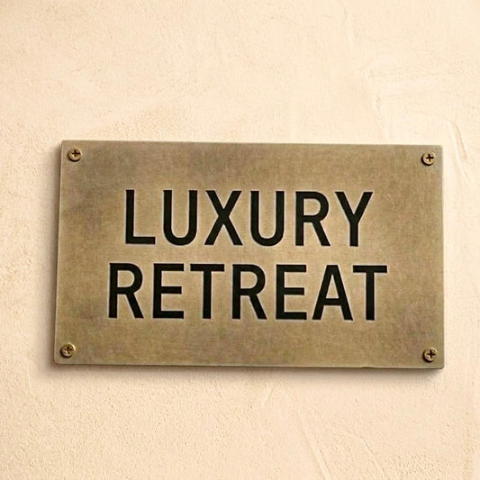 Custom Solid Brass Sign reading 'Luxury Retreat' with four corner screws.⁠