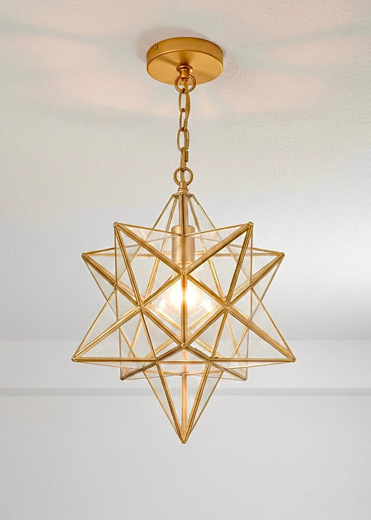 Handmade Moroccan Moravian star pendant light in polished brass gold finish with clear glass panels.