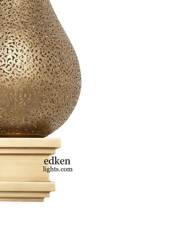 Traditional gold-finished Moroccan brass wall lamp shown in natural daylight, highlighting the artisan craftsmanship.