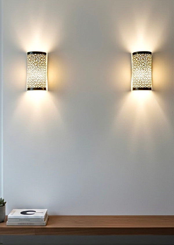 Artisanal Moroccan brass wall lamp providing atmospheric lighting in a high-end hallway.