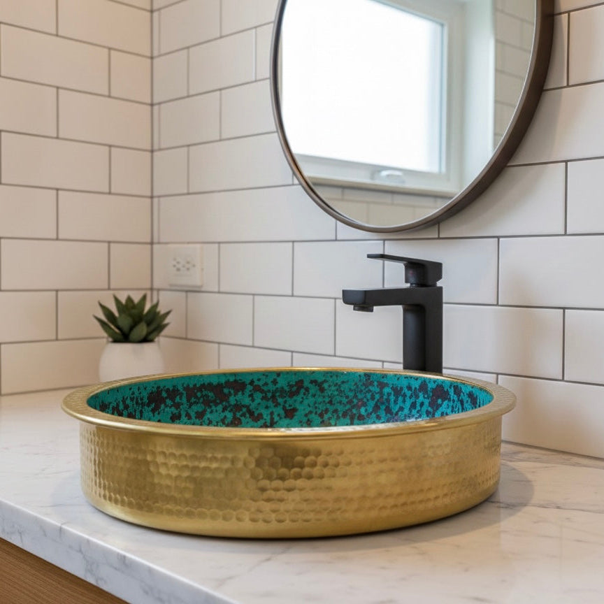 Detailed close-up of the hand-hammered texture on a gold brass sink showing artisan craftsmanship.