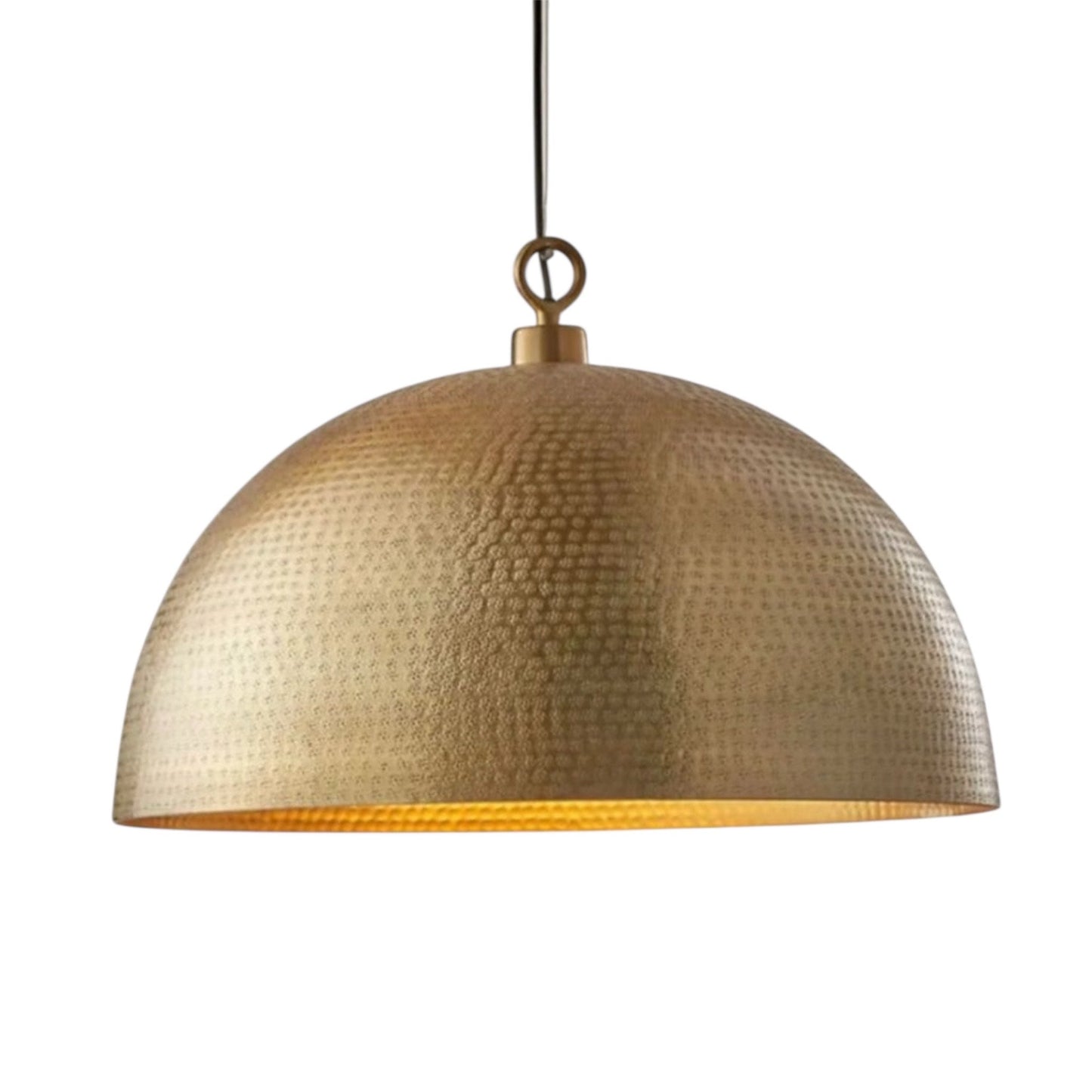 Close-up of the artisanal hand-hammered texture on a solid brass dome lamp.