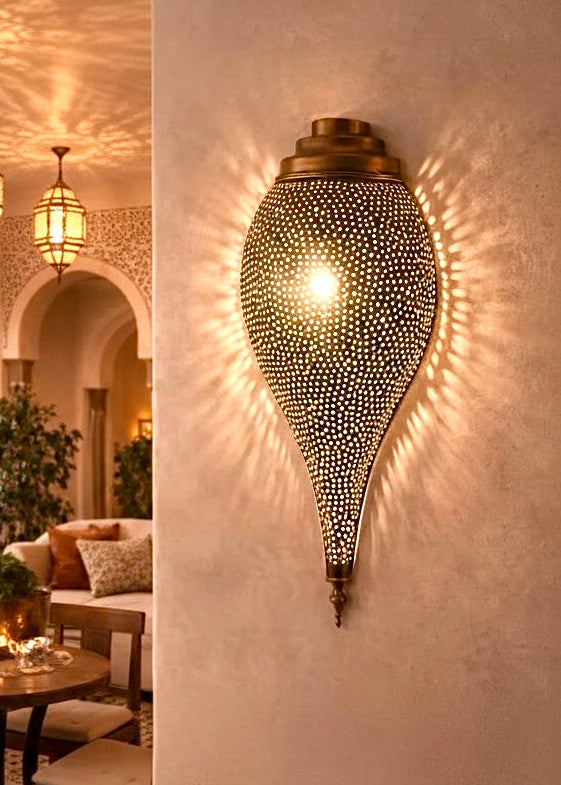 Boho-chic living room interior featuring handcrafted Moroccan brass wall lighting.