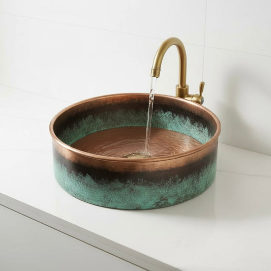 Handcrafted circular copper basin with dark oxidized accents and turquoise patina textures.