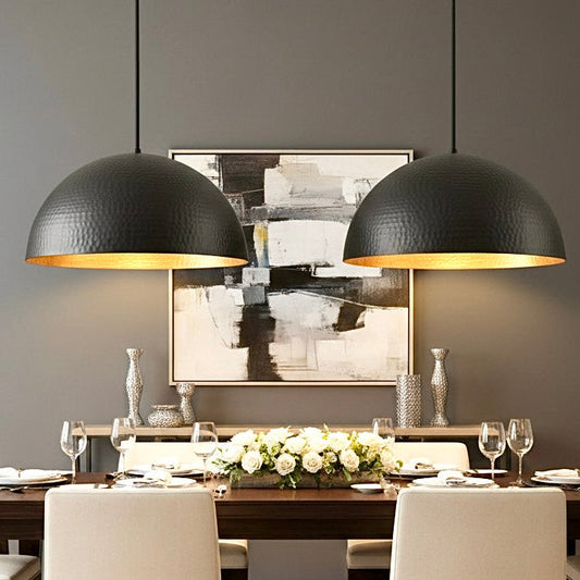 Handmade dome lamp featuring a hand-hammered gold brass finish inside a black shell.